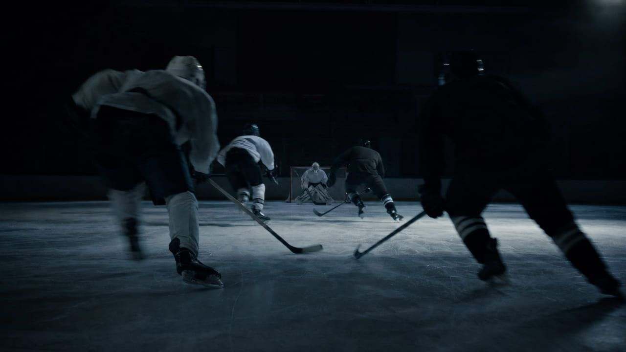 Ice hockey players in motion under cold rink lighting, seen from a broadcast angle